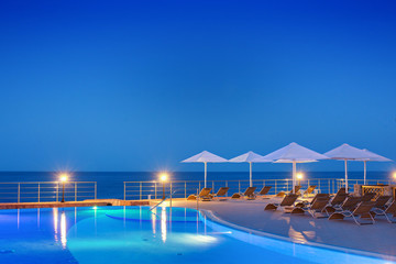 Swimming pool at night with sea view