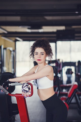 Curly girl with relaxing in the gym