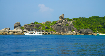 Stones and rocks paradise lagoon. White ship near big stones in lagoon. Seascape. Thailand. Andaman Sea.