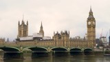 4K video of traffic and people on Westminster Bridge over the River Thames next to Big Ben and The Houses of Parliament, London, England
