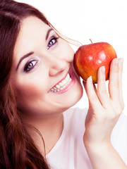 Woman holds apple fruit close to face, isolated