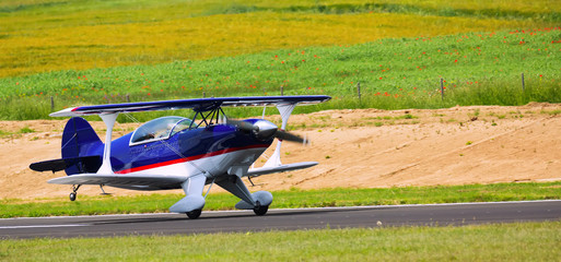 Light aircraft landing on aerodrome runway