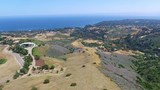 Aerial drone view of the ocean with mountains and hills in Los Angeles California