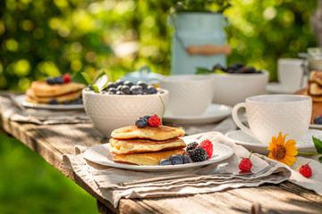 Enjoy your pancakes served with coffee in garden