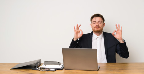 Businessman in a office in zen pose