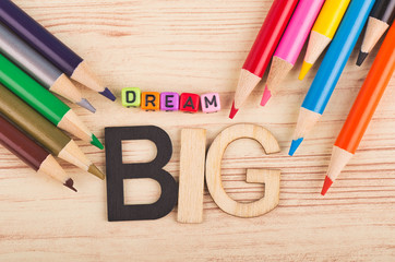 Business success concept, DREAM BIG word on wooden desk