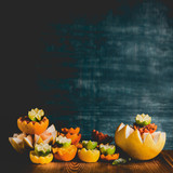 Variety of colorful citrus fruits half on table at dark background. Copy space. Tropical citrus fruits assortment. Vitamin C. Healthy lifestyle