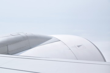 plane wing and cloud floating on sky through window frame