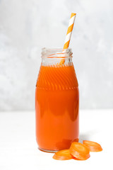 fresh carrot juice in a bottle, closeup