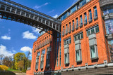 metal structure of footbridge and Red brick wall in an old brewery in Poznan.
