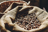 A bag of roasted coffee beans, standing at the window of the house.