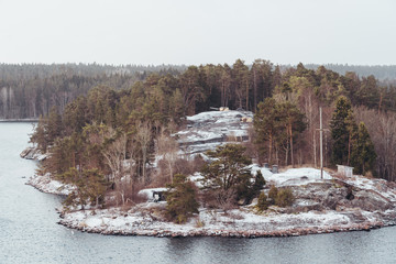 Defense positions behind trees in one of the Stockholm archipelago islands on a snowy day