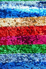 Sequins background.sequins striped fabric.Texture scales with Sequins close-up.Sequins multicolored stripe.Scales background.Shiny texture sequin material