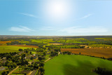 Village with farms in countryside in summer