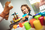 Cute child playing on table indoor, selective focus.