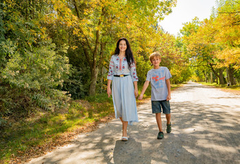 happy mother and son on the background of autumn trees