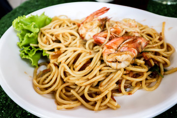 Closeup of Spaghetti with spicy prawn on white dish
