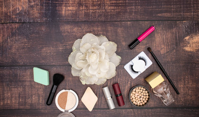 Make up beauty and cosmetics products for woman on wooden background 