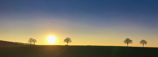 Panorama with beautiful landscape in Germany with trees in the sunset