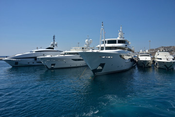 beautiful white yachts moored in the port of Mykonos