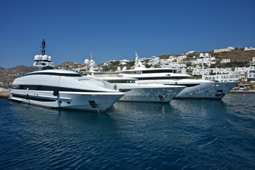  beautiful white yachts moored in the port of Mykonos