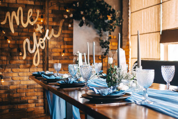 This photo shows a wedding, festive table. Wedding decorations. Wedding table setting. Beautiful glasses and dishes