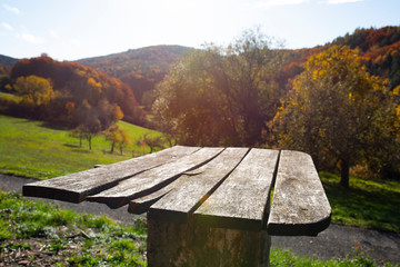 Wooden table in an autumn landscape