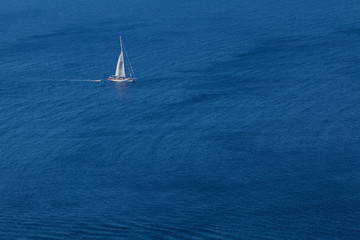 White yacht on blue sea background