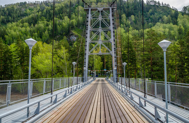Combined pedestrian and road bridge over the mountain river
