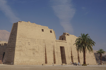 Luxor, Egypt: The first pylon of Medinet Habu, New Kingdom mortuary temple of Ramesses III on the West Bank of the Nile River.