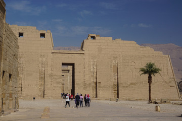 Luxor, Egypt: Tourists visit Medinet Habu, the mortuary temple of Ramesses III, an important New Kingdom structure on the West Bank of the Nile River.