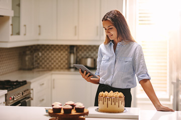 Female chef with tablet pc in kitchen