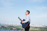 Musical Concept. Casual man playing practicing guitar.