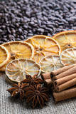 coffee beans with citrus cinnamon sticks and star anise on the background of burlap
