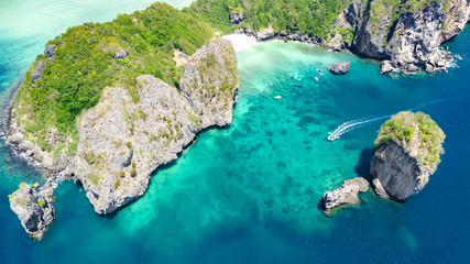 Aerial drone view of tropical islands, beaches and boats in blue clear Andaman sea water from above, beautiful archipelago islands of Krabi, Thailand