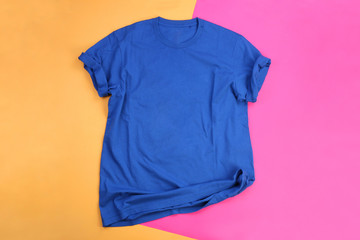 Wrinkled blue mockup t-shirt on orange and pink pastel background