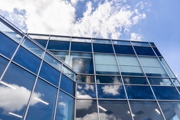 White Clouds and Blue Sky Reflection on Office Building