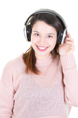 young woman with headphones looks in camera on white background