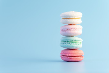 Sweet french macaroons cake pastel colored or macarons with vintage pastel blue colored background