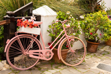 pink recycled upcyckled bicyckle made into a flower holder