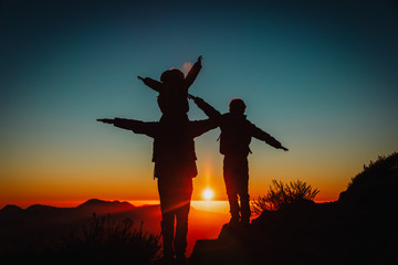 father with kids travel in sunset mountains, family hiking in nature