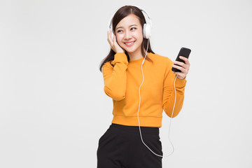 Beauty young Asian woman listening music with headphones in playlist song application on smartphone