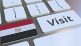 VISIT text and flag of Egypt on the buttons on the computer keyboard. Conceptual 3D animation