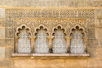 Traditional Moroccan window in moorish style of architecture and ornament on stone wall