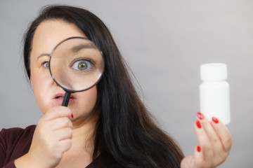 Woman investigating ingredients of medicines