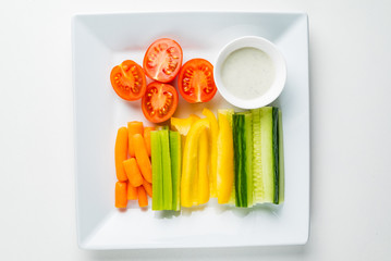 fresh organic vegetables with dip on the white background