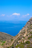 greek landscape in naxos with meadow, mountain and blue sky.
