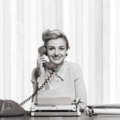 Attractive young woman speaking on vintage phone
