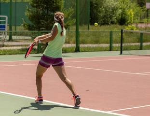 Girl playing tennis on the court