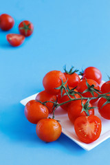 Cherry tomatoes on a blue background